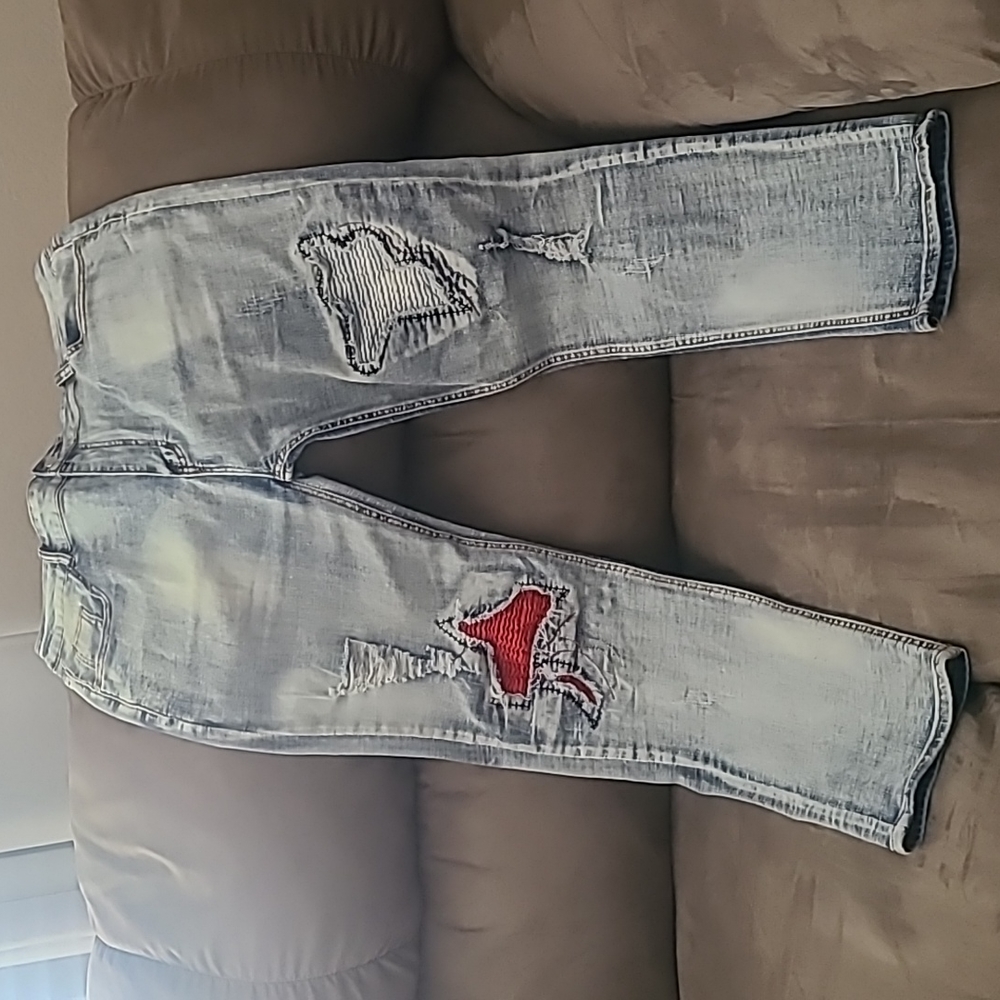 Ripped jeans with red patchwork